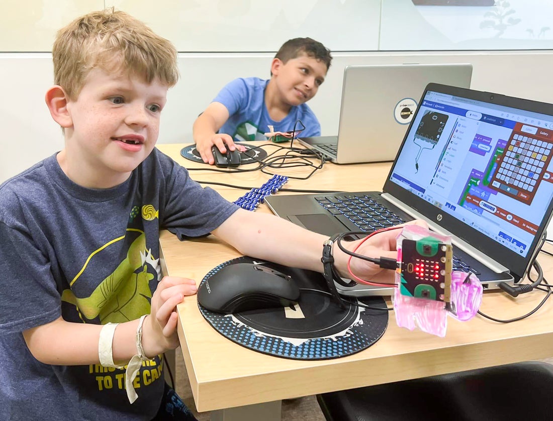 Hone their computer skills with the best coding classes for kids in Boston! Photo courtesy of Code Ninjas 