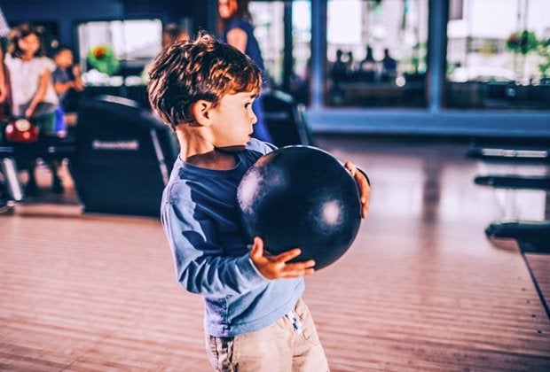 Little boy trying for a strike! Photo courtesy of Pinstripes