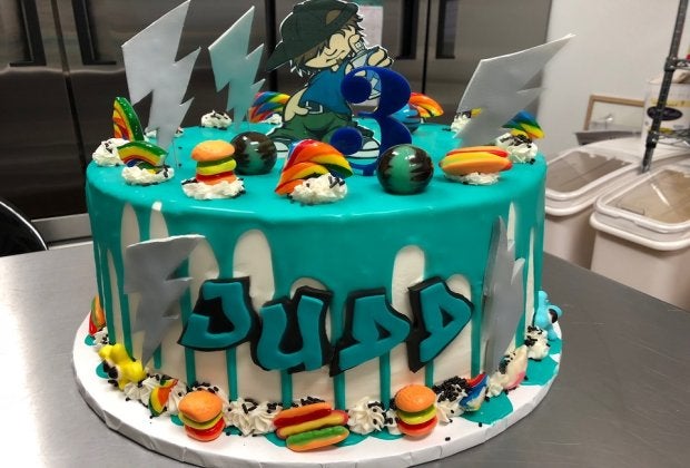 At Armonk's Sugar Hi, specialty cakes include a brightly-colored ganache drip with candy pieces. Photo courtesy of Sugar Hi